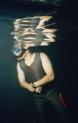 A dive instructor keeps an eye on his novice Open Water s... by Michael Grebler 